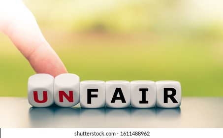 Hand Turns Dice And Changes The Word Unfair To Fair.