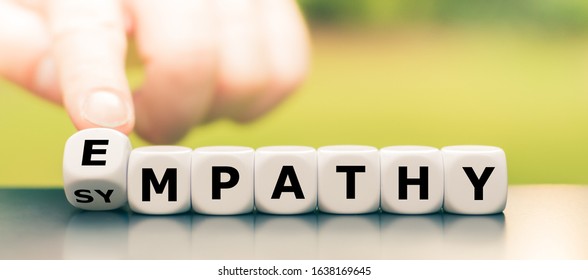 Hand turns dice and changes the word "sympathy" to "empathy".