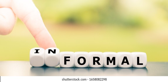 Hand turns a dice and changes the word "formal" to "informal". - Shutterstock ID 1658082298