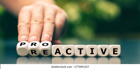 Hand turns dice and changes the word reactive to proactive.