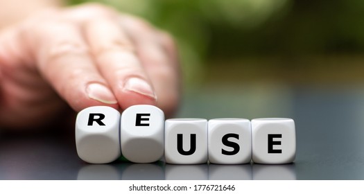 Hand turns dice and changes the word use to reuse. - Shutterstock ID 1776721646