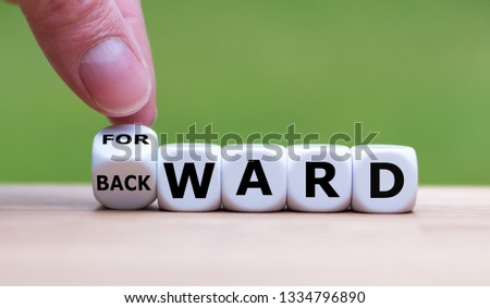 Hand turns a dice and changes the word 