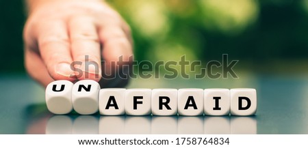 Hand turns dice and changes the word 