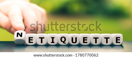 Hand turns dice and changes the word etiquette to netiquette.