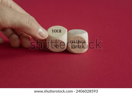 Hand turns a wooden cube and change the expression my feelings matter to your feelings matter. Beautiful red background, copy space.