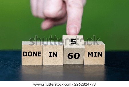 Hand turns wooden cubes and changes the expression 'done in 60 min' to 'done in 5 min'.