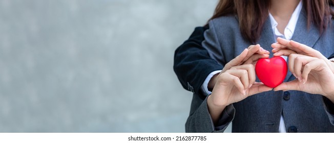 Hand Of Two Asian Generation Z Women Lgbtq Lesbian With Red Heart Celebrate Annual In June Social Of Gay, Lesbian, Bisexual, Transgender, Human Rights