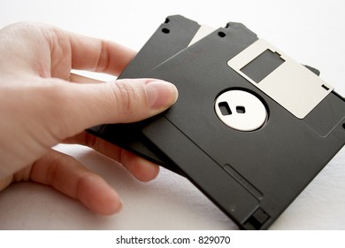 Hand with two floppy discs