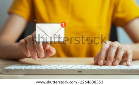 Hand type a message on the keyboard and hand touching on a digital screen of new email notifications, messages to deliver.
