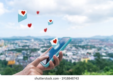 Hand Typing Love Letter Email In Smartphone Social Network Online Community  With Social Media Love Letter Mail Send Out Icons Valentine Concept.