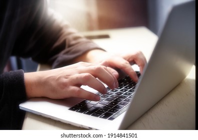 Hand Typing On Computer Keyboard. Male Hands With Laptop. Man In A Housecoat Working Remote At Home. Online Courses. With Blur And Shallow Depth Of Field