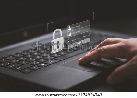 Hand typing on keyboard laptop computer to input username and password for or technology security system and prevent hacker concept.