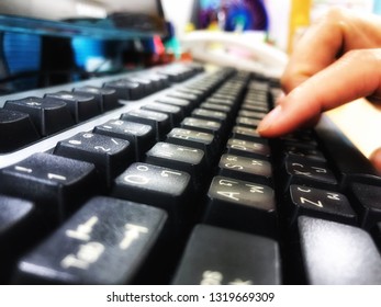 Woman’s hand typing on keyboard in the office