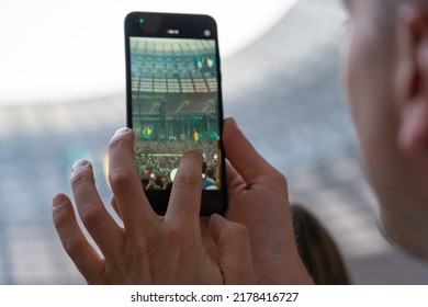 Hand Of Unidentified Man Records Video With Mobile Smart Phone Of Concert Stage. Taking Photo On Front Stage On Summer Outdoor Music Concert Festival.