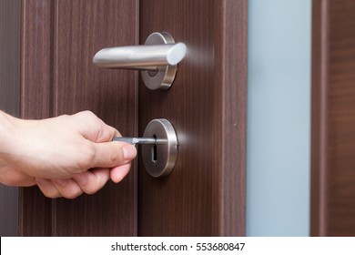 Hand Unlocking House Door