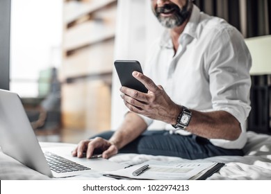 Hand of unrecognisable businessman typing on cell phone. - Powered by Shutterstock