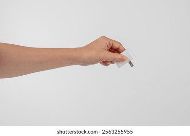 Hand and USB cables adapter, USB type A C universal plug cable, mobile phone accessory charger on white background.