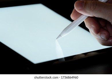 Hand Use  Pen Stylus Touch And Drow On Tablet Screen Mock Up With Light. Concept For Mobile Phone Technology And Future Look.