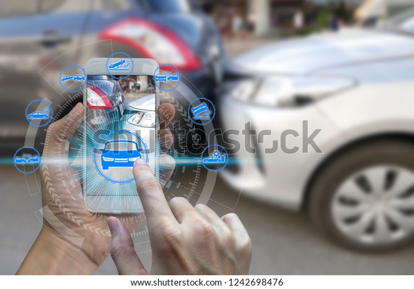 Hand use smartphone with car claim icons over
the Network connection on car crash background, car accident for
car insuranc claim
concept.
