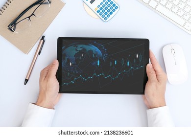 Hand Uses A Tablet To Analyze Sales Data And An Economic Graph Chart In Order To Restart Business Growth And Analysing Forex Trading Grap