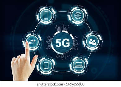 Hand using abstract 5G interface with computing icons on dark background. Internet speed and web concept - Powered by Shutterstock - Get 15% off with code: PIKWIZARD15