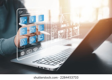 Hand using AI smart tablet with smart home app on the room, circular interface of the smart home automation assistant on the virtual screen and user touches the button, smart home digital interface  - Shutterstock ID 2284453733