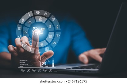 Hand using AI smart tablet with smart home app on the room, circular interface of the smart home automation assistant on the virtual screen and user touches the button, smart home digital interface  - Powered by Shutterstock