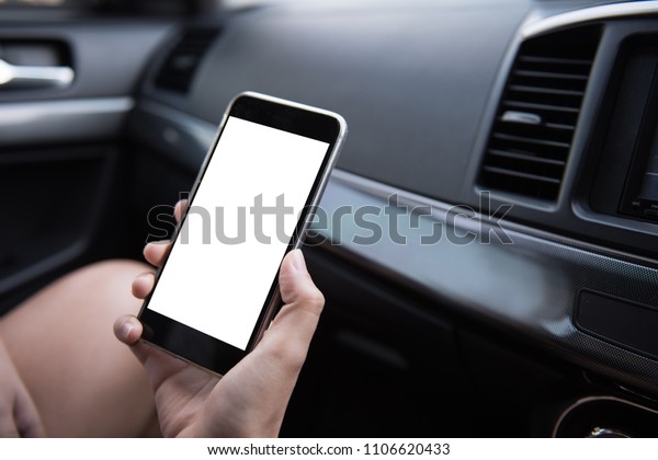 Hand
using blank white screen mobile smartphone inside a car in sunny
day, copy space for your app or product
display,