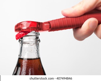 A Hand Using Bottle Opener To Open The Soda