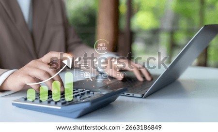 Hand using a calculator with the net zero carbon concept and green growth chart. Sustainability finance planning, CO2 footprint analysis, ESG reporting, and climate action business strategy.