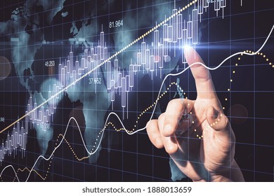 Hand using candlestick chart with digital world map hologram. Global and invest concept.
