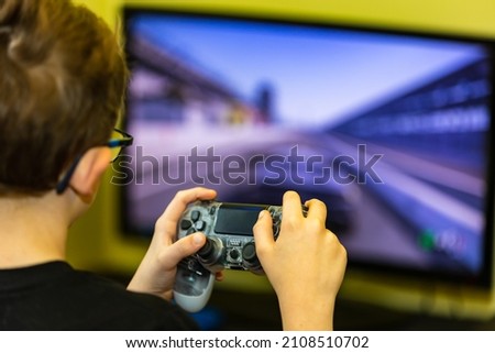 Hand using contoller to play video game.
