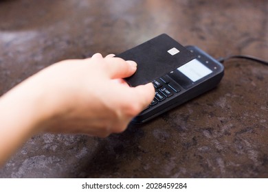 Hand Using Credit Card With NFC Technology In A Supermarket Close Up.