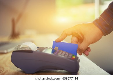 Hand Using Credit Card Swiping Machine Entering Credit Card Code To Pay Shopping Online.creditcard Swipe Through Terminal For Payment In Shop,buy And Sell Products & Service,internet Of Things,vintage