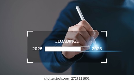 Hand using digital pen loading progress bar from 2025 to 2026. Concept of future planning, business transition, goal setting, technology development, strategic roadmap, and new year progress.