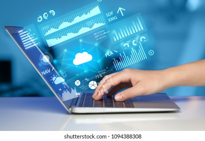 Hand using laptop with cloud technology and linked information concept - Shutterstock ID 1094388308