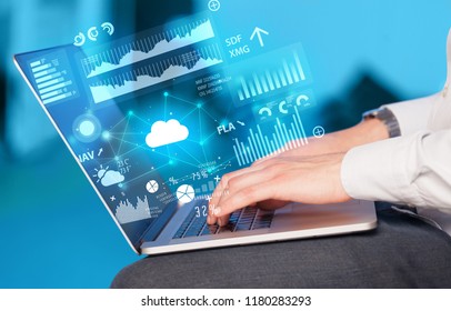 Hand using laptop with cloud technology and linked information concept - Shutterstock ID 1180283293