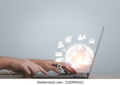 Hand using laptop to connection to the world network.  Big data analytics and business intelligence. Global business composition concept on a world map. The Metaverse technology of digital links. - Shutterstock ID 2120992412
