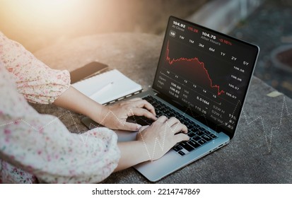 Hand using laptop with planning and strategy, Stock market, Business growth down, Concept of financial crisis, echnical price graph and indicator, red candlestick chart with analyzing forex trading.