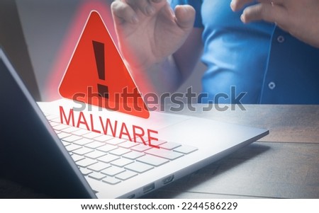Hand using laptop and show malware screen. Hack password and personal data. . Person Looking At Laptop Screen Showing Malware Text. Internet network security concept