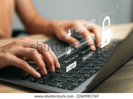 Hand using laptop and type your username and password to access the system, login screen, private data and prevent identity.
