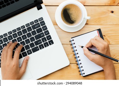 hand using laptop and write note inspire idea on wood desk - Powered by Shutterstock