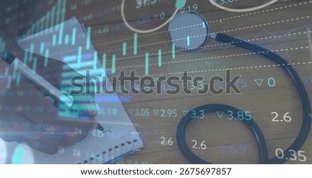 Hand using metallic pen noting on notebook at desk with stethoscope, stock data overlay, copy space. Corporate, finance, workspace, business, analytics, professional, modern