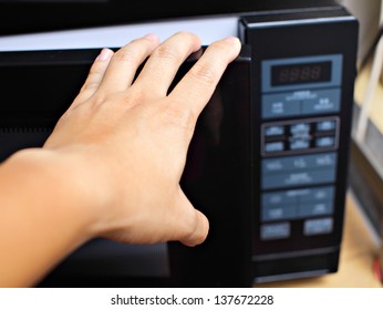 Hand Using Microwave Oven