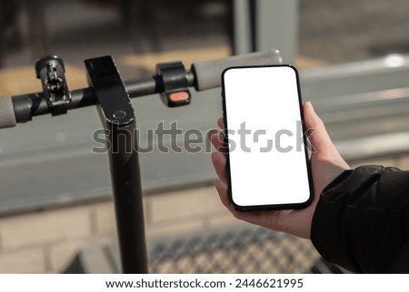 Hand using mobile phone screen mockup, smartphone app for renting kick scooter.