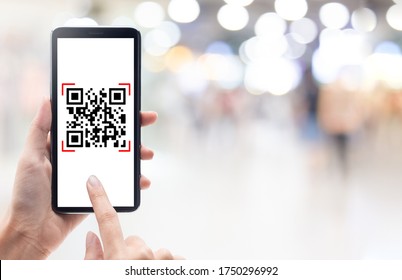 Hand Using Mobile Smart Phone Scan Qr Code On Shopping Mall Background. Barcode Reader, Qr Code Payment, Cashless Technology, Digital Money Concept.