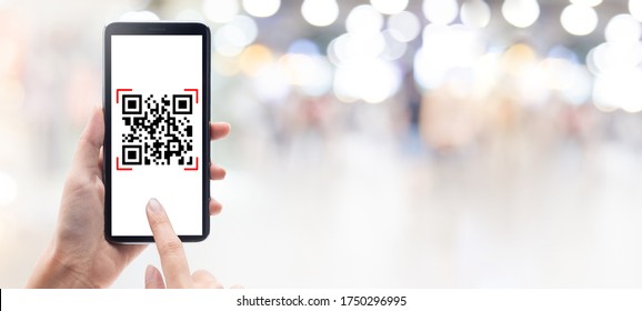 Hand using mobile smart phone scan Qr code on shopping mall banner background. Barcode reader, Qr code payment, Cashless technology, Digital money concept. - Shutterstock ID 1750296995