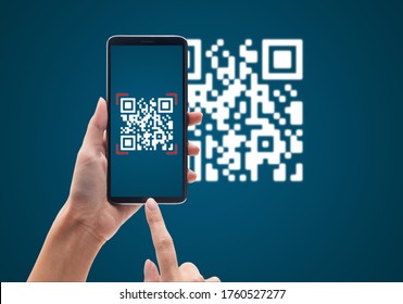 Hand Using Mobile Smart Phone Scan Qr Code On Blue Background. Cashless Technology And Digital Money Concept.