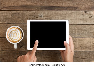 hand using mock up tablet similar to ipades style on wood desk with clipping path display easy add element
