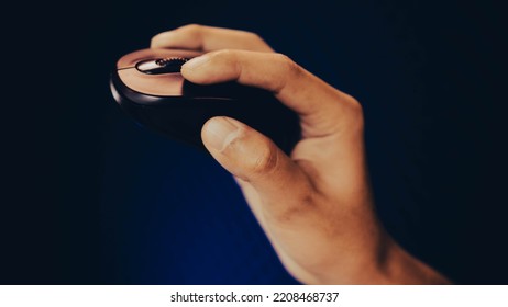 Hand Using A Modern Ergonomic Wireless Computer Mouse, Holding And Moving In The Air, Object On Side View